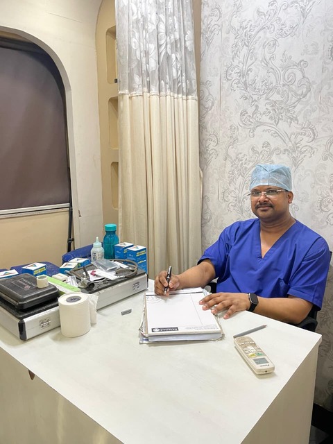 Physiotherapist applying kinesio tape to patient's back